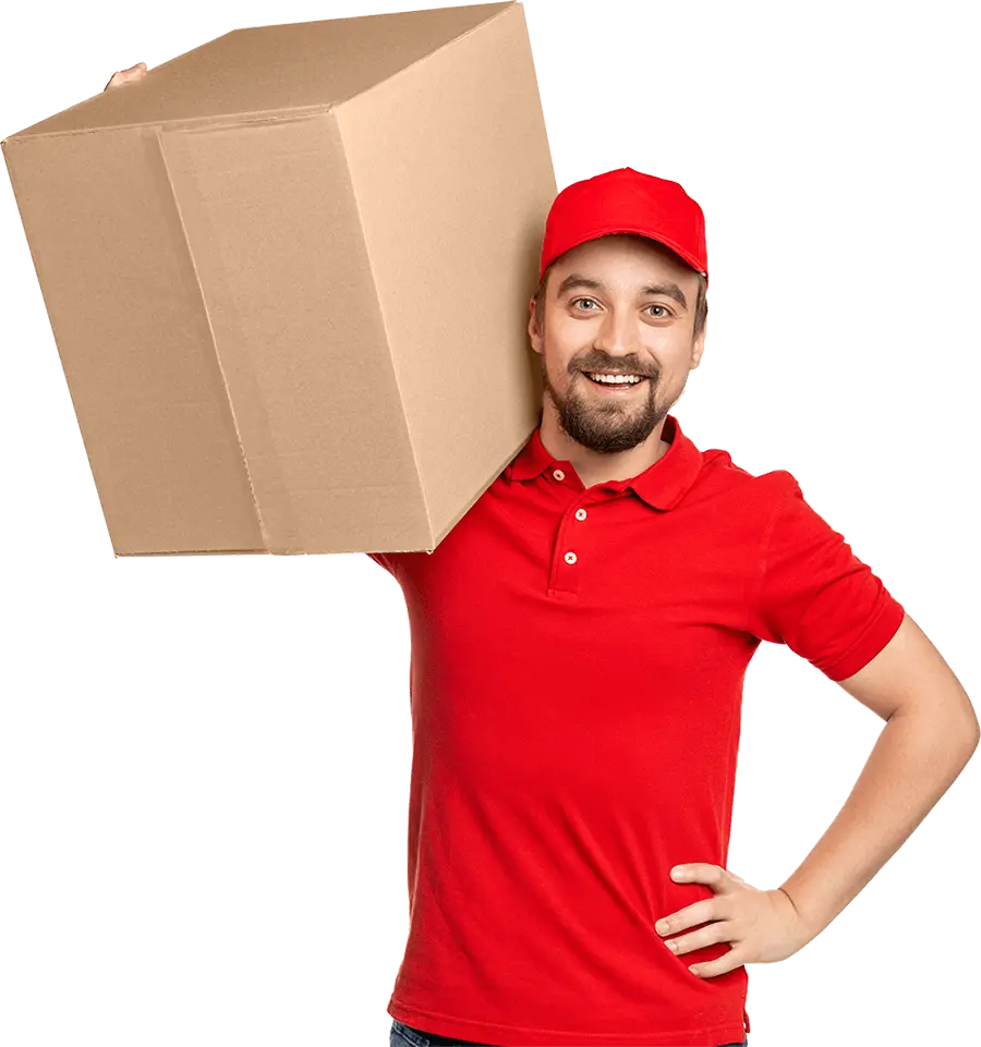 Bearded delivery courier in a red cap and polo shirt carrying a cardboard box on his shoulder and looking sideways